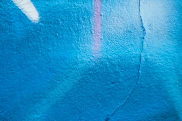 closeup of blue graffiti on the wall texture