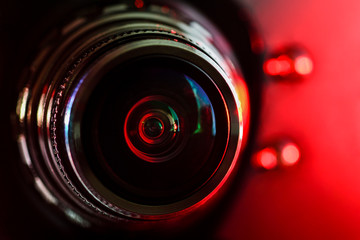 Camera lens and red backlight . Horizontal photography