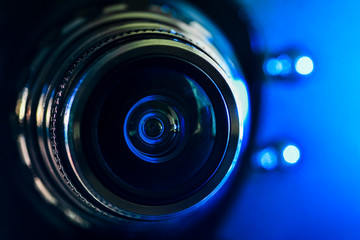 The camera lens and blue backlighting . Horizontal photography