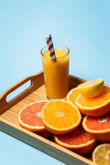 cut in half juicy citruses on a blue background