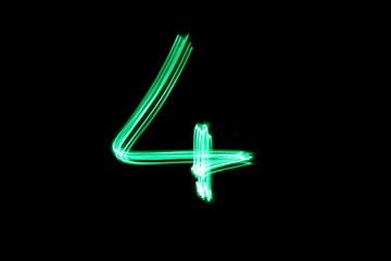 Long exposure, light painting photography.  Single number four in a vibrant neon green colour...