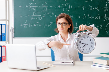Female math teacher in front of the chalkboard 