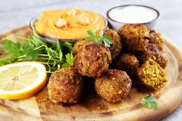 Traditional homemade hummus, falafel and chickpea served with spices on table. Jewish Cuisine.