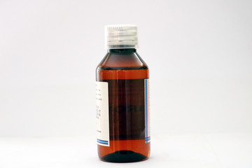 An amber colored medicine pet bottle with transparent dosage cap
