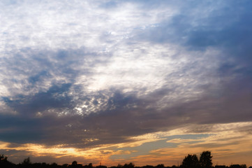 Sunset over the sea. Reflection of sunlight in the sea waves. Red and yellow sky in the rays of the sunset.