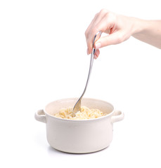 Noodles in a plate fork in hand on a white background. Isolation
