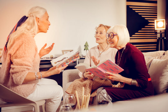 Pleasant emotional woman reading her favourite book