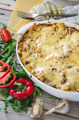Traditional lasagna made with minced beef bolognese sauce and bechamel sauce with pepper and herbs
