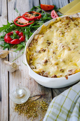 Traditional lasagna made with minced beef bolognese sauce and bechamel sauce with pepper and herbs