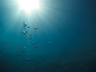 Fototapeta na wymiar Underwater background with sun rays and bubbles