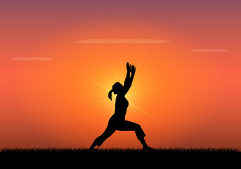 Silhouette of woman doing yoga at sunset