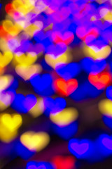 abstract multicolored lights background with bokeh hearts