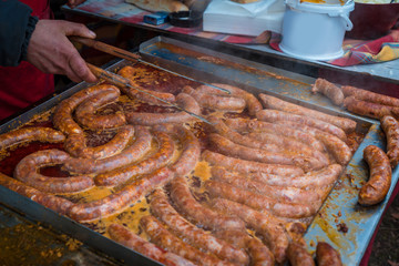 baking of delicious and seasoned traditional sausages in a deep fat 