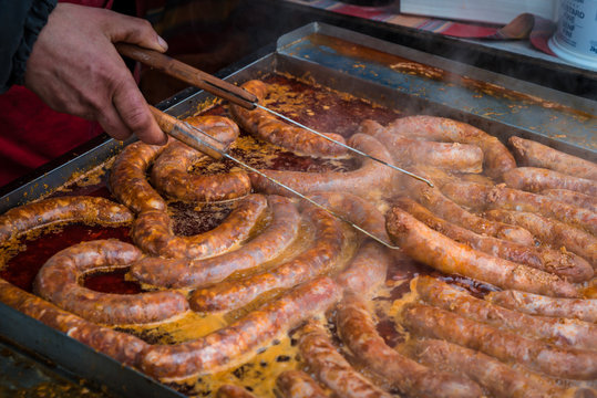 baking of delicious and seasoned traditional sausages in a deep fat 