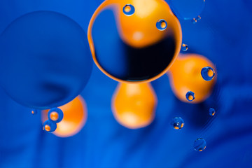 Orange funny smiley face on a blue canvas
