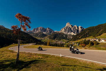Motorcycle in the autumn on a pass road with blue sky