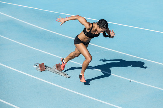 young woman training on running track