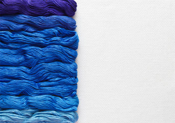 Threads of blue hues are set in a row.