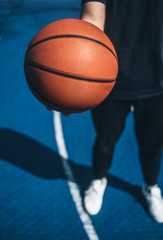 Man holds the ball for basketball