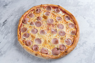 Tasty pizza with sausage on white background