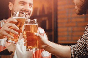 Party in pub, clinking glasses of beer, funny friends laugh