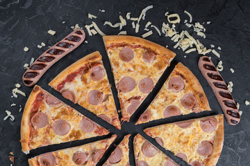 Tasty pizza with sausage on black background