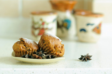 Two muffins on a saucer with Badian stars.