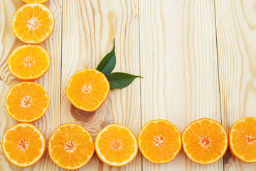 Creative orange background. Slices of citrus fruits on a wooden background. Summer background. Copy space. Top view.