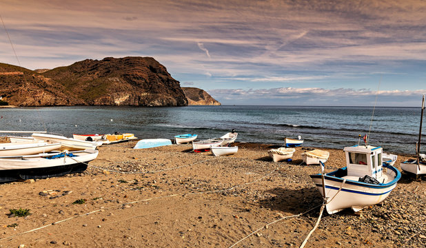 Mediterranean beach with fishing boats ashore in Cabo de Gata park in Almeria, southern Spain.