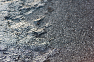 Texture of dirty ice on asphalt