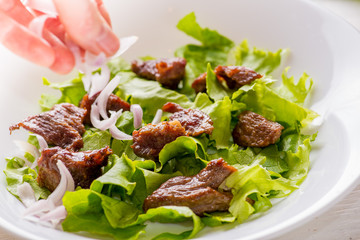hand dressing with onion ready salad