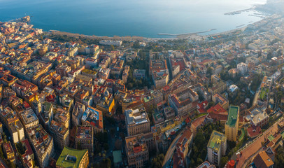 Panoramic aerial view of the waterfront of Naples, the Chiaia and Mergellina districts, from the Vomero hill. There are Castle dell' Ovo and many buildings in the narrow streets of the city.