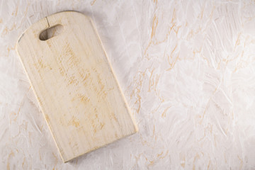 Wooden cutting board on a gray marble background