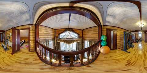 full seamlee panorama 360 degrees angle view in interior hall room in wooden village vacation home with exercise machines in equirectangular spherical  projection.