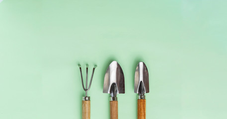 Collection of gardening, trowel, spade and rake on a green background. Garden tools.