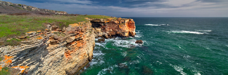 Fototapeta na wymiar Beautiful landscape with blue sea and rocky shore - panoramic view