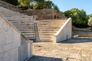 Ancient theater with marble seats and stairs. The Acropolis of Rhodes. Rhodes island, Greece