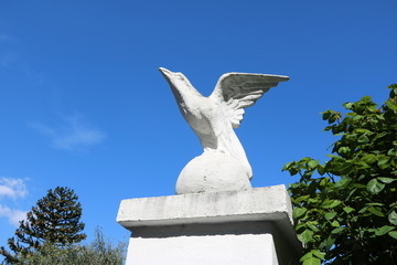 White golden eagle sculpture under blue sky