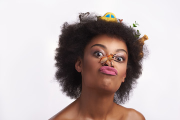 Ethnic lady grimace with bee on her nose