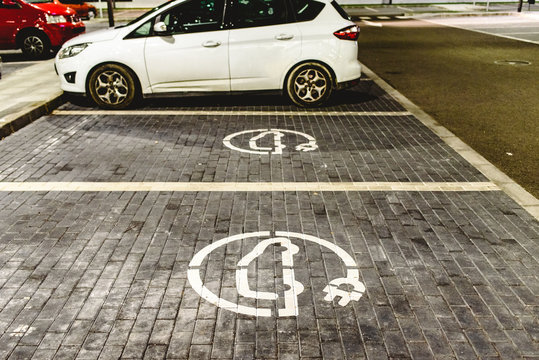 Roadsign of free electric car charging station in a European supermarket parking lot.
