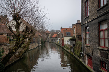 Fototapeta na wymiar View of canal at Bruges with historical houses on both sides