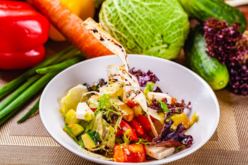 Fattoush salad with different vegetables on white plate