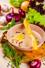 Mushroom cream soup with parmesan cheese in beige plate