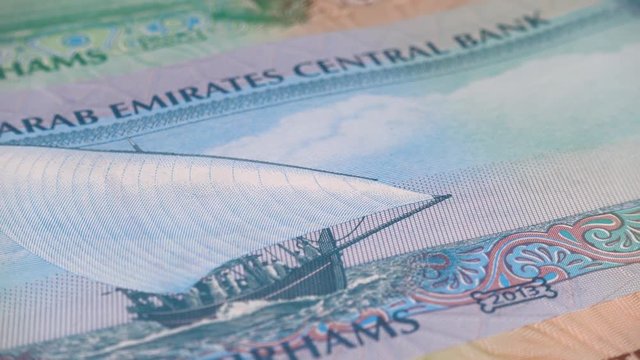 UAE dirham notes slow rotating. Emirates money currency. Low angle. Stock video footage
