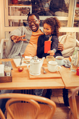 Father and daughter making funny faces and gestures for photo