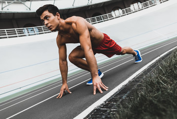 Serene man wearing sport clothes during training