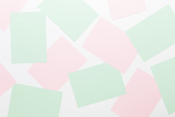 Abstract geometric background in light pastel tones from sheets of thick pale past paper.