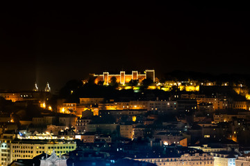 Naklejka premium Saint George Castle at night, moorish citadel an the top of Lisbon, Portugal