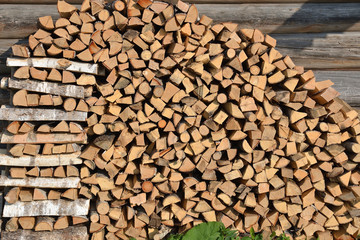 Stack of firewood at the wall of the house
