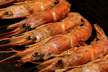 appetizer for beer large red shrimps argentine in chitin one-piece set lies on grill raw stage cooking sea food menu background